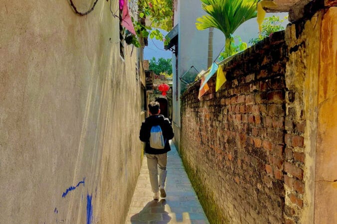 Bat Trang village tour includes walking through a winding alley in the old village.