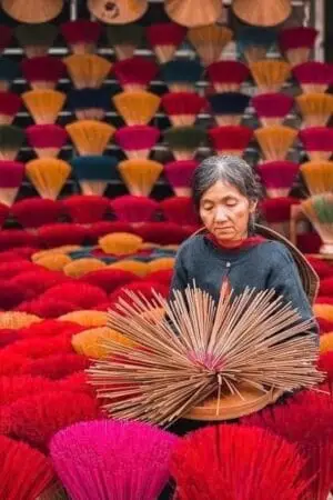 Skilled artisans are inspecting bamboo sticks at the traditional incense-making village of Quang Phu Cau.