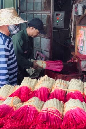 A local artisan traditionally dyeing incense sticks in Quang Phu Cau village.