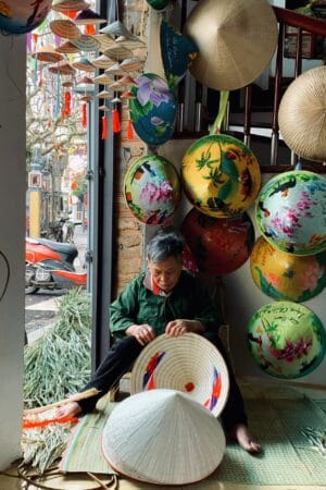 Artisans are making conical hats in Chuong conical hat village.