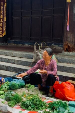 Elderly Vietnamese women selling vegetables at a rural market.