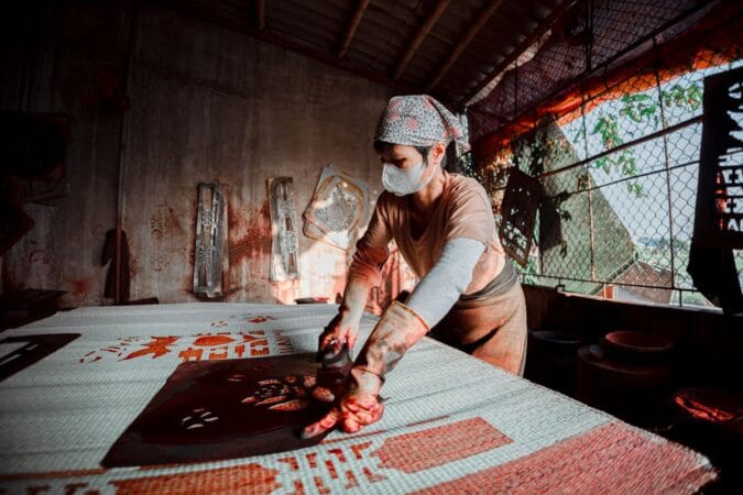 Experienced artisan decorating lacquerware in a Hanoi hidden gems craft tour.